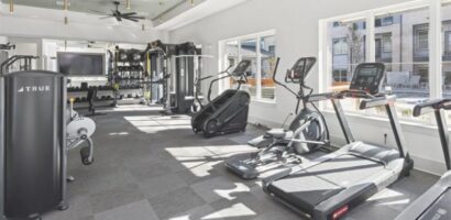 Modern commercial fitness facility with cardio and strength equipment